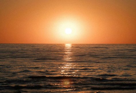 Reflection of setting sun in ocean